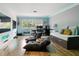 Modern bedroom with a work area, daybed, wood floors, and ample natural light, offering a flexible living space at 27740 Water Ash Dr, Wesley Chapel, FL 33544
