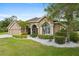 Beautiful single-story home featuring meticulous landscaping with flowering bushes at 27740 Water Ash Dr, Wesley Chapel, FL 33544