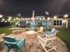 Outdoor fire pit surrounded by Adirondack chairs, perfect for evening gatherings at 27740 Water Ash Dr, Wesley Chapel, FL 33544