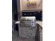 Close up of the stainless-steel grill with granite countertops and stone accents at 27740 Water Ash Dr, Wesley Chapel, FL 33544