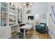 Charming home office with custom built-ins, a modern desk, and stylish decor, creating a productive workspace at 27740 Water Ash Dr, Wesley Chapel, FL 33544