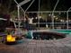 Relaxing hot tub with string lights, landscaping, and privacy screening at 27740 Water Ash Dr, Wesley Chapel, FL 33544
