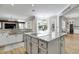 Open kitchen featuring an island, granite countertops, modern appliances, and ample natural light at 27740 Water Ash Dr, Wesley Chapel, FL 33544