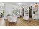Bright living room featuring modern furniture, wood floors, and wine storage, creating an elegant and inviting space at 27740 Water Ash Dr, Wesley Chapel, FL 33544