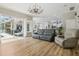 Open concept living room flows into kitchen with seating area overlooking the lanai at 27740 Water Ash Dr, Wesley Chapel, FL 33544