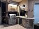 Well-equipped outdoor kitchen featuring a built-in grill, counter space, and stylish stone accents at 27740 Water Ash Dr, Wesley Chapel, FL 33544