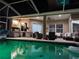 Screened pool area with outdoor kitchen and plenty of room for seating and entertaining at 27740 Water Ash Dr, Wesley Chapel, FL 33544