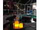 Relaxing poolside ambiance with decorative candles and a lush garden backdrop under string lights at 27740 Water Ash Dr, Wesley Chapel, FL 33544