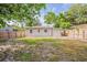 Spacious fenced backyard with a lawn and a shed offers a private outdoor space at 4226 E Emma St, Tampa, FL 33610