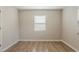 A bright bedroom with wood-look floors and a window with horizontal blinds at 4226 E Emma St, Tampa, FL 33610