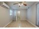 Cozy bedroom features tile flooring, air conditioner and ceiling fan at 4226 E Emma St, Tampa, FL 33610