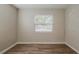 Bedroom with a window offering natural light and wood-look flooring throughout at 4226 E Emma St, Tampa, FL 33610