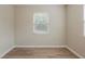 A bright, airy bedroom with wood-look flooring and a window with blinds at 4226 E Emma St, Tampa, FL 33610