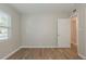 A bright room featuring wood-look floors with a door to another room at 4226 E Emma St, Tampa, FL 33610