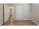 A well-lit bedroom showcasing wood-look floors with doorways to other rooms at 4226 E Emma St, Tampa, FL 33610