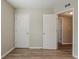 Bedroom with two closets, wood-look floors, and a view to other rooms at 4226 E Emma St, Tampa, FL 33610