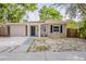Charming single-story home featuring a freshly painted facade, a minimalist front yard, and a welcoming entrance at 4226 E Emma St, Tampa, FL 33610