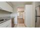 Functional kitchen features modern appliances, granite countertops, and ample white cabinet space at 4226 E Emma St, Tampa, FL 33610