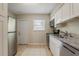Functional kitchen featuring stainless steel appliances, granite countertops, and ample cabinet space with a backyard access at 4226 E Emma St, Tampa, FL 33610