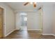 Spacious living room featuring sleek laminate flooring with a ceiling fan at 4226 E Emma St, Tampa, FL 33610