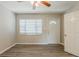 Bright living room featuring sleek laminate flooring, a ceiling fan, a big window for natural light and a white front door at 4226 E Emma St, Tampa, FL 33610