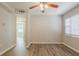 Bright living room featuring sleek laminate flooring and a ceiling fan at 4226 E Emma St, Tampa, FL 33610