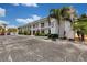 Exterior of building with palm trees, and a sign that reads Sunset Plaza East at 680 71St Ave # 9, St Pete Beach, FL 33706