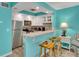 The kitchen features white cabinets, stainless steel appliances, and counter seating at 680 71St Ave # 9, St Pete Beach, FL 33706