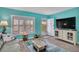 Inviting living room featuring plantation shutters, a television, and neutral-toned furniture at 680 71St Ave # 9, St Pete Beach, FL 33706