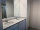 Bathroom with double sinks, granite countertop, and modern fixtures at 32122 Eastern Redbud Br, San Antonio, FL 33576