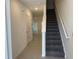 Entryway featuring staircase leading to second floor, tile flooring and open floor plan at 32122 Eastern Redbud Br, San Antonio, FL 33576