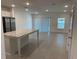 Open-concept kitchen and living area with granite countertop island and modern appliances at 32122 Eastern Redbud Br, San Antonio, FL 33576