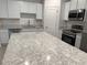 Bright kitchen featuring a large island with granite countertops and stainless appliances at 32122 Eastern Redbud Br, San Antonio, FL 33576
