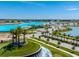 Scenic aerial view of community with palm trees, clear water, and amenities at 32128 Eastern Redbud Br, San Antonio, FL 33576