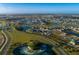 Wide aerial community view of attractive homes, water features, and greenery at 32128 Eastern Redbud Br, San Antonio, FL 33576