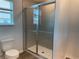 Bathroom featuring a glass-enclosed shower with tile surround at 32128 Eastern Redbud Br, San Antonio, FL 33576