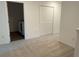 Upstairs hallway with a laundry closet and a folding door closet at 32128 Eastern Redbud Br, San Antonio, FL 33576