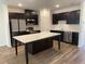 Modern kitchen with stainless steel appliances, a center island, and dark wood cabinetry at 32128 Eastern Redbud Br, San Antonio, FL 33576