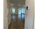 Bright and airy living area with wood-look floors and a sliding glass door at 32128 Eastern Redbud Br, San Antonio, FL 33576