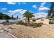 Beautiful backyard featuring a large palm tree, decorative rock beds, and a cozy patio at 5511 1St Avenue Nw Dr, Bradenton, FL 34209