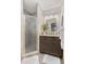 Bathroom with a glass-enclosed shower, granite vanity, modern lighting, and neutral tones for a spa-like feel at 5511 1St Avenue Nw Dr, Bradenton, FL 34209