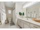 Bathroom with a large vanity, ample lighting, and white tiling, offering a clean and functional space at 5511 1St Avenue Nw Dr, Bradenton, FL 34209