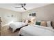 Bright bedroom with two twin beds, ceiling fan, and window, creating a cozy and inviting space at 5511 1St Avenue Nw Dr, Bradenton, FL 34209