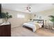 Serene bedroom with a queen-size bed, ceiling fan, neutral walls, and ambient lighting at 5511 1St Avenue Nw Dr, Bradenton, FL 34209