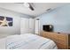 Bedroom featuring a comfortable bed, ceiling fan, and closet with TV and dresser combination at 5511 1St Avenue Nw Dr, Bradenton, FL 34209
