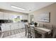 Bright kitchen featuring white cabinets, stainless steel appliances and an adjacent dining area at 5511 1St Avenue Nw Dr, Bradenton, FL 34209