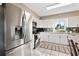 Modern kitchen featuring white cabinets, stainless steel appliances, and granite countertops at 5511 1St Avenue Nw Dr, Bradenton, FL 34209