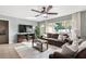 Inviting living room with a large window providing natural light, comfortable seating, and a ceiling fan at 5511 1St Avenue Nw Dr, Bradenton, FL 34209