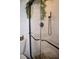 Close-up of a tiled shower with glass doors, sleek fixtures, and pebble flooring, adding a modern touch at 821 Silver Springs Nw Ter, Port Charlotte, FL 33948