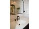 Bathroom with modern finishes including black faucet, decor and a large mirror at 821 Silver Springs Nw Ter, Port Charlotte, FL 33948